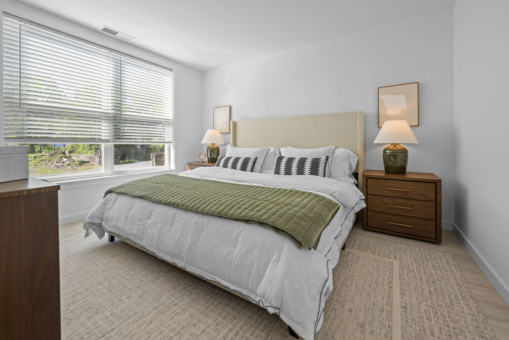 Ltd bedroom with white comforter and beige carpet in PA